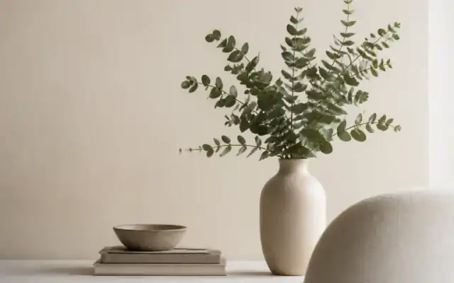 Neutral ceramic vase with eucalyptus in a calm wellness interior